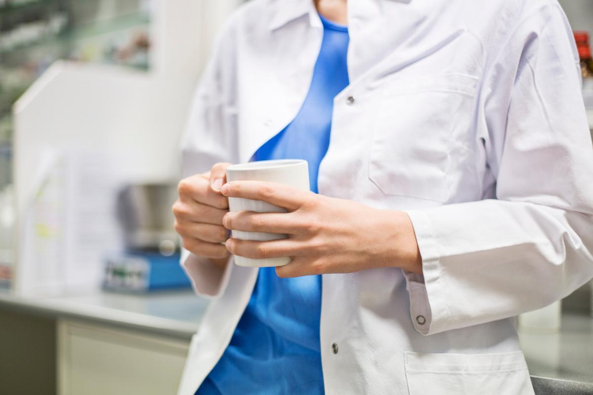 Person holding coffee cup